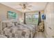 Bedroom featuring a king-size bed, wicker chair, and plantation shutters at 4350 Chatham Dr # E307, Longboat Key, FL 34228