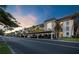 Modern condominium building with covered parking at dusk at 4350 Chatham Dr # E307, Longboat Key, FL 34228