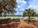 Peaceful lakeside bench with scenic view of calm water under a sunny sky at 7360 Oak Moss Dr # 4, Sarasota, FL 34241