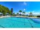 Inviting swimming pool with waterfront views and lounge chairs at 4350 Chatham Dr # E307, Longboat Key, FL 34228
