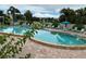 Community pool with lounge chairs and umbrellas at 4480 Ironwood Cir # 308A, Bradenton, FL 34209