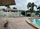 Community patio area with tables, chairs, and a pergola at 4480 Ironwood Cir # 308A, Bradenton, FL 34209