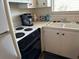 Well-equipped kitchen with a stove, oven, and double sink at 4480 Ironwood Cir # 308A, Bradenton, FL 34209