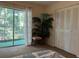 Bedroom with sliding door to balcony, closet, and plant at 4480 Ironwood Cir # 308A, Bradenton, FL 34209