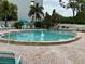 Inviting community pool with lounge chairs and brick patio at 4480 Ironwood Cir # 308A, Bradenton, FL 34209