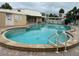 Kidney shaped community pool with surrounding patio at 4480 Ironwood Cir # 308A, Bradenton, FL 34209