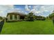 Spacious backyard with lush green lawn, a privacy fence, and mature landscaping at 4914 Savona Run, Bradenton, FL 34211