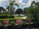 Serene pond view with lush landscaping at 13575 Salinas St, Venice, FL 34293