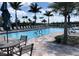 Resort-style pool with plenty of lounge chairs and patio tables at 13575 Salinas St, Venice, FL 34293