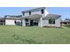 Large backyard with grassy lawn and an outdoor kitchen at 2605 Waterfront Cir, Sarasota, FL 34240