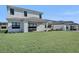 Spacious backyard with grassy lawn and outdoor kitchen area at 2605 Waterfront Cir, Sarasota, FL 34240