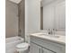 Modern bathroom with grey cabinets and a large mirror at 2605 Waterfront Cir, Sarasota, FL 34240