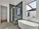 Modern bathroom with a large soaking tub, walk-in shower, and hexagon tile at 2605 Waterfront Cir, Sarasota, FL 34240