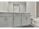 Double vanity bathroom with gray cabinets and quartz countertops at 2605 Waterfront Cir, Sarasota, FL 34240