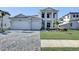 Two-story home with a three-car garage and a landscaped front yard at 2605 Waterfront Cir, Sarasota, FL 34240