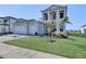 Two-story home with gray brick driveway and landscaped lawn at 2605 Waterfront Cir, Sarasota, FL 34240