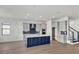 Modern kitchen with blue island and white cabinets at 2605 Waterfront Cir, Sarasota, FL 34240
