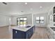 Modern kitchen with island, lake view, and hardwood floors at 2605 Waterfront Cir, Sarasota, FL 34240