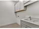 Laundry room with white cabinets and quartz countertop at 2605 Waterfront Cir, Sarasota, FL 34240