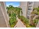 Courtyard walkway with lush tropical landscaping at 6157 Midnight Pass Rd # E24, Sarasota, FL 34242