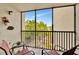 Screened balcony with patio furniture and tropical views at 6157 Midnight Pass Rd # E24, Sarasota, FL 34242
