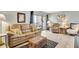 Living room with leather sofas, wicker coffee table, and tiled floors at 6157 Midnight Pass Rd # E24, Sarasota, FL 34242