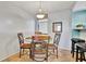 Bright dining area with glass table and four chairs at 6157 Midnight Pass Rd # E24, Sarasota, FL 34242