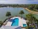 Community pool and hot tub with palm trees and lounge chairs at 10520 Boardwalk Loop # 302, Bradenton, FL 34202
