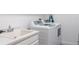 Laundry room with washer, dryer, and utility sink at 10520 Boardwalk Loop # 302, Bradenton, FL 34202