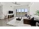 Spacious living room with large windows, a comfy couch, and a beautiful view at 10520 Boardwalk Loop # 302, Bradenton, FL 34202