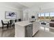 Open concept kitchen with island, white cabinets and stainless steel appliances at 10520 Boardwalk Loop # 302, Bradenton, FL 34202