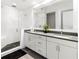 Modern bathroom with double sinks and a glass shower at 10520 Boardwalk Loop # 302, Bradenton, FL 34202