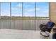 Spacious balcony overlooking lake with wicker chairs at 10520 Boardwalk Loop # 302, Bradenton, FL 34202