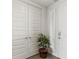 Bright entryway with white doors and potted plant at 10520 Boardwalk Loop # 302, Bradenton, FL 34202