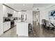 Open concept kitchen with white cabinets, stainless steel appliances, and an island at 10520 Boardwalk Loop # 302, Bradenton, FL 34202