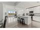 Modern kitchen with white cabinetry, island, and lake views at 10520 Boardwalk Loop # 302, Bradenton, FL 34202