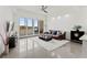 Living room with a large window, brown couch, and a fluffy rug at 10520 Boardwalk Loop # 302, Bradenton, FL 34202