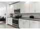 Modern kitchen with white cabinets, stainless steel appliances and dark countertops at 10520 Boardwalk Loop # 302, Bradenton, FL 34202