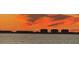 Dramatic sunset over the cityscape, reflecting on the water at 3301 Bay Shore Rd, Sarasota, FL 34234