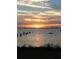 Sunset over calm water with pilings and birds at 3301 Bay Shore Rd, Sarasota, FL 34234