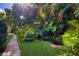 Relaxing garden path leads to a tranquil pond, surrounded by lush tropical foliage at 3301 Bay Shore Rd, Sarasota, FL 34234
