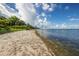 Sandy beach with calm water and seagrass at 3301 Bay Shore Rd, Sarasota, FL 34234