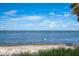 White sand beach with calm water and distant shoreline at 3301 Bay Shore Rd, Sarasota, FL 34234