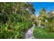 Relaxing pathway through a vibrant tropical garden at 3301 Bay Shore Rd, Sarasota, FL 34234