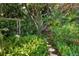 Peaceful garden path surrounded by tropical foliage at 3301 Bay Shore Rd, Sarasota, FL 34234