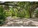 Lush backyard with a basketball hoop and mature trees at 3301 Bay Shore Rd, Sarasota, FL 34234