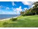 Lush lawn extends to the water's edge, offering breathtaking bay views at 3301 Bay Shore Rd, Sarasota, FL 34234