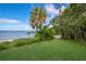 Scenic waterfront view with lush lawn and kayak at 3301 Bay Shore Rd, Sarasota, FL 34234
