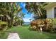 Landscaped backyard with water view and walkway at 3301 Bay Shore Rd, Sarasota, FL 34234