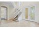 Bright entryway with double doors, tiled floor, and a grand staircase at 10115 Day Lily Ct, Bradenton, FL 34212